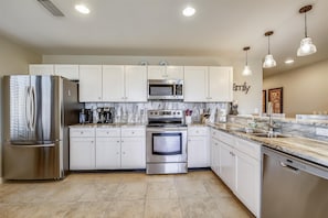 Kitchen is fully stocked and has stainless steel appliances
