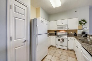 Kitchen area includes range, microwave, dishwasher, fridge/freezer, standard coffee maker, and pantry.