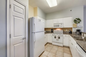 Kitchen area includes range, microwave, dishwasher, fridge/freezer, standard coffee maker, and pantry.