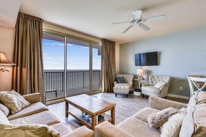 Living room with sleeper sofa and entrance onto the balcony