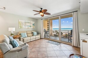 Living room with sofa and loveseat with balcony view