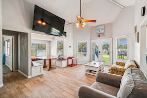 Open concept Dining and Living room with TV leading to Porch