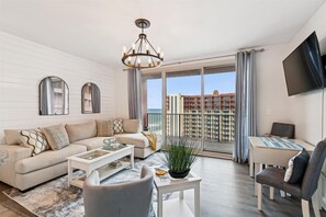 Living room with sectional sofa and chair
Dining area
TV
Balcony with view