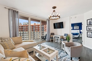 Living room with sectional sofa and chair
Dining area
TV
Balcony with view