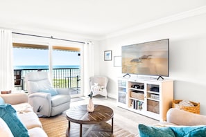 Open concept living room leads to private balcony