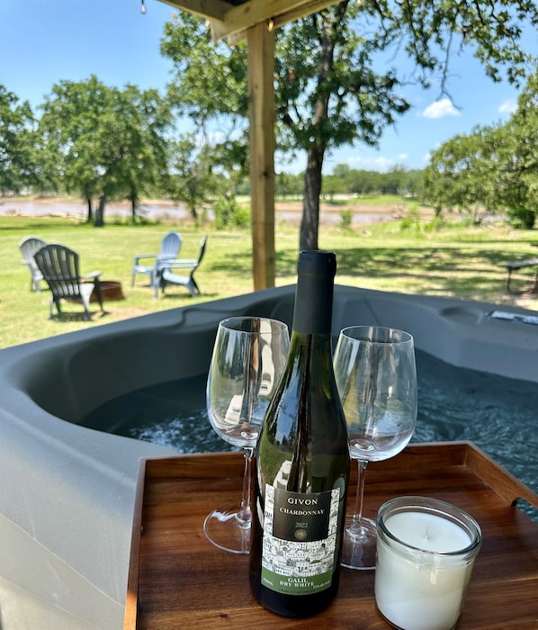 Unwind in your private hot tub with a glass of wine and the serene sounds of the lake