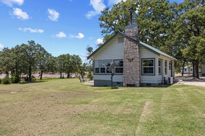 Welcome to your cabin, surrounded by trees and open views of the lake just steps away.