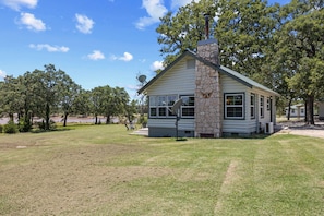 Welcome to your cabin, surrounded by trees and open views of the lake just steps away.