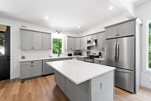 Kitchen with spacious island, dishwasher, and drip-style coffee maker