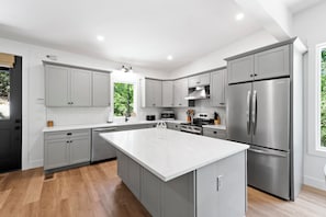 Kitchen with spacious island, dishwasher, and drip-style coffee maker