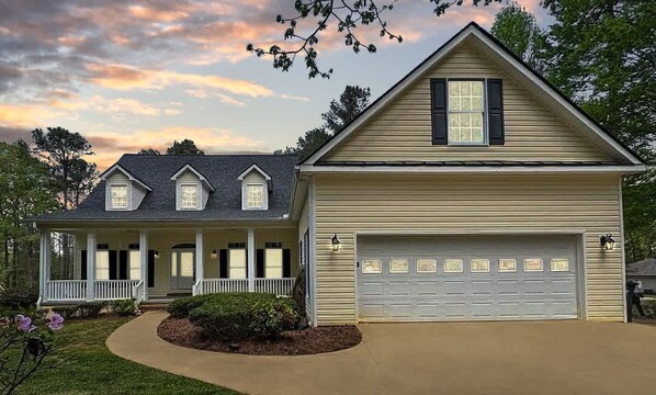A warm Southern welcome awaits at this lake-access retreat. The inviting front porch, manicured landscaping, and spacious two-car garage set the tone for comfort, charm, and convenience—just moments from the water's edge.
