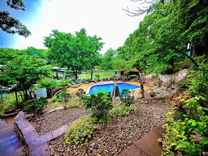 Descend to the inviting communal pool area at Lakefront Treetop Village, offering a refreshing oasis with stunning views of the lake and surrounding greenery.