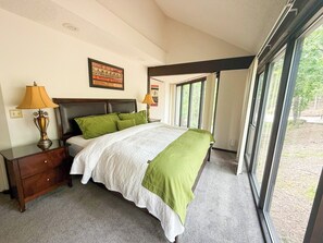 Let the forest be your backdrop—cozy up in this serene and naturally lit bedroom retreat.