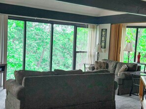 Gather with family or friends in the inviting living area of this charming treetop retreat.