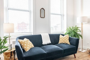 This airy studio features full-length windows, lush ferns, and rich navy accents—perfect for morning coffee or evening wine. #JunoLofts #StratfordStay #BoutiqueStudio #DesignApartment #BrightSpaces #UrbanRetreat #IndoorPlants #LoftStyle