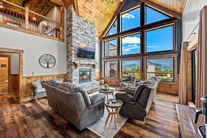 Floor to ceiling windows, smart TV, and electric fireplace in the living area.