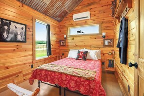 Bedroom 2 also has a queen size bed with  equestrian themed decor.