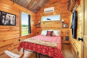 Bedroom 2 also has a queen size bed with equestrian themed decor.