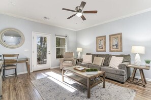 Unwind in this inviting, light-filled living area w/ an attached enclosed patio.
