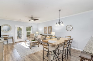 Spacious dining area with seating for six connected to the living room.