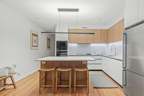 Gather around the central island, doubling as a dining table, ideal for casual meals, morning coffees, or evening wine.