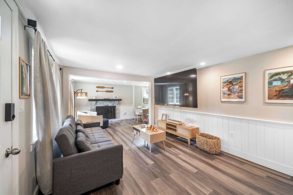 Enjoy a beautifully designed open-concept living area filled with natural light and thoughtfully arranged for comfort and style. This inviting space features an impressive 85" Smart TV, perfect for movie nights or relaxing after a day of exploring. 