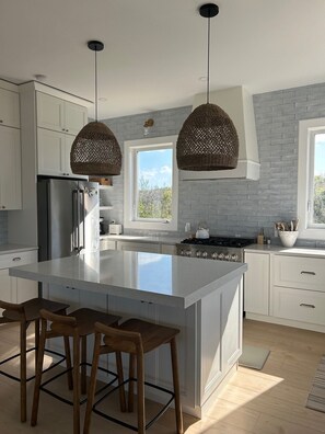 Gas stove and built in microwave drawer and Caesar stone countertop