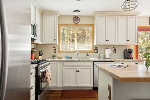 Step into the heart of your Big Bear retreat – our fully upgraded kitchen! The expansive center island, complete with comfortable barstools, invites gatherings and casual meals.