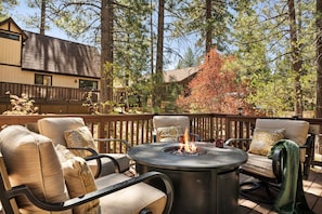 As dusk settles, the inviting glow of the firepit sets the scene for an unforgettable evening.