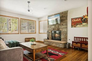 The living room features a gas/wood burning fireplace and Smart TV to stream your favorite shows.
