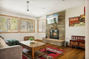 The living room features a gas/wood burning fireplace and Smart TV to stream your favorite shows.