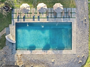Enjoy our Junior Olympic-sized swimming pool with a slide! Perfect for swimming laps, relaxing, or just soaking up the sun!