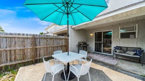Enjoy outdoor living in the private fenced backyard, complete with a shaded dining area and a gas grill perfect for cookouts. A cozy bench adds a comfortable touch, making it an ideal spot to relax with morning coffee or evening drinks. This peaceful pati
