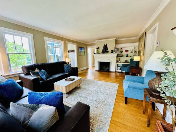 Spacious living room with an indoor fireplace
