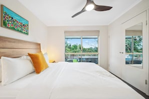 Bushland views from the queen bed in the first bedroom—let the greenery greet you with every sunrise.