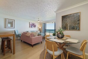 Gather for meals at the glass dining table for four, the perfect spot to savour local produce or plan your next beach adventure.