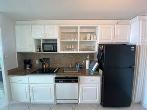 Fully stocked kitchen with all appliances.