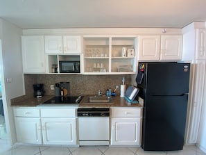 Fully stocked kitchen with all appliances.