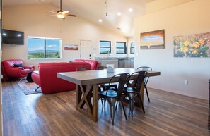 Large open living area with local art and dining table