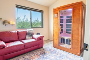 Relaxation room with sauna, yoga mats, and blankets
