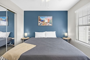 King-size bed, plush linens & workspace - perfect for comfort and productivity.