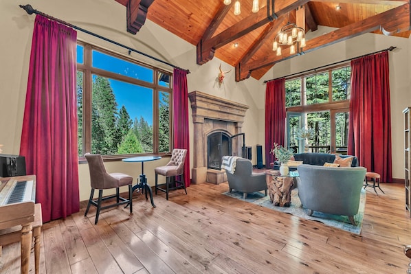 Living room 1: Main floor, wood-burning fireplace, piano, Smart TV, access to deck