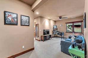 Game room: Upper floor, Smart TV, Nintendo Wii, PS4, pinball machine, shared bathroom access, adjacent to two queen bedrooms