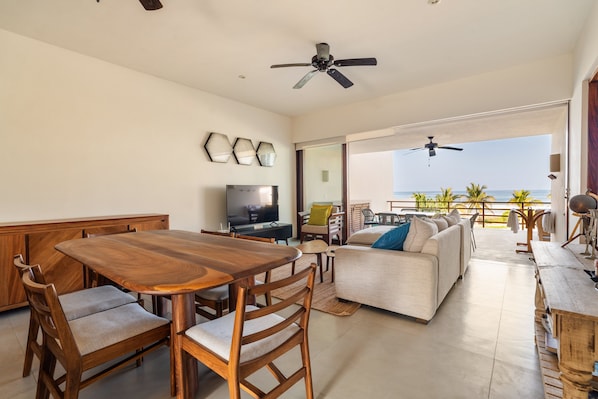 This cozy living space flows out to the terrace through sliding glass doors, allowing indoor comfort with an outdoor feel.