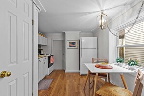 Start your day right! Our charming fully kitchen features a delightful dining area, perfect for enjoying breakfast with a view.