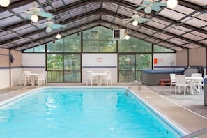 Enjoy year-round swimming in the expansive indoor pool, featuring a large hot tub for ultimate relaxation. The bright, airy space is perfect for family fun or unwinding after a day of activities.
