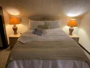 Plush bedding, soft lighting, and serene surroundings make this bedroom a guest favorite.