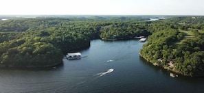 This expansive aerial view showcases the stunning Lake of the Ozarks, surrounded by vibrant fall foliage, offering a truly picturesque setting. The property boasts multiple boat docks, providing convenient access to the water for all your aquatic adventures.