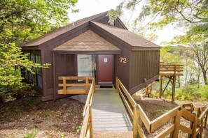 This elevated modern home offers a unique "treetop" living experience, seamlessly blending with its lush surroundings. Expansive windows invite abundant natural light and showcase breathtaking views, creating a bright, airy retreat that feels both luxurious and deeply connected to nature.