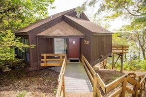 This elevated modern home offers a unique "treetop" living experience, seamlessly blending with its lush surroundings. Expansive windows invite abundant natural light and showcase breathtaking views, creating a bright, airy retreat that feels both luxurious and deeply connected to nature.